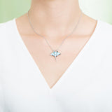 The picture shows a model wearing a 925 sterling silver larimar manta ray pendant.