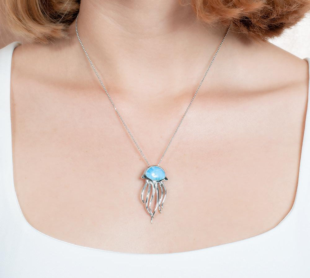 The picture shows a model wearing a 925 sterling silver larimar medusa jellyfish pendant.