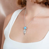 The picture shows a model wearing a 925 sterling silver larimar medusa jellyfish pendant.