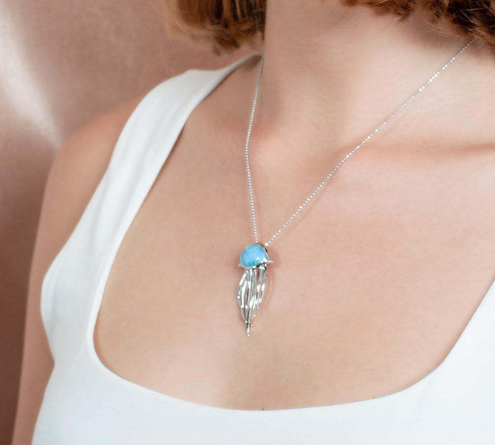 The picture shows a model wearing a 925 sterling silver larimar medusa jellyfish pendant.