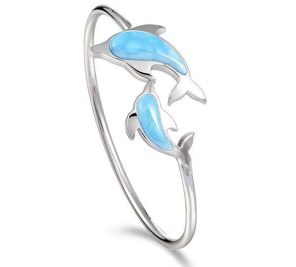 The picture shows a 925 sterling silver two dolphin lovers bangle with larimar.