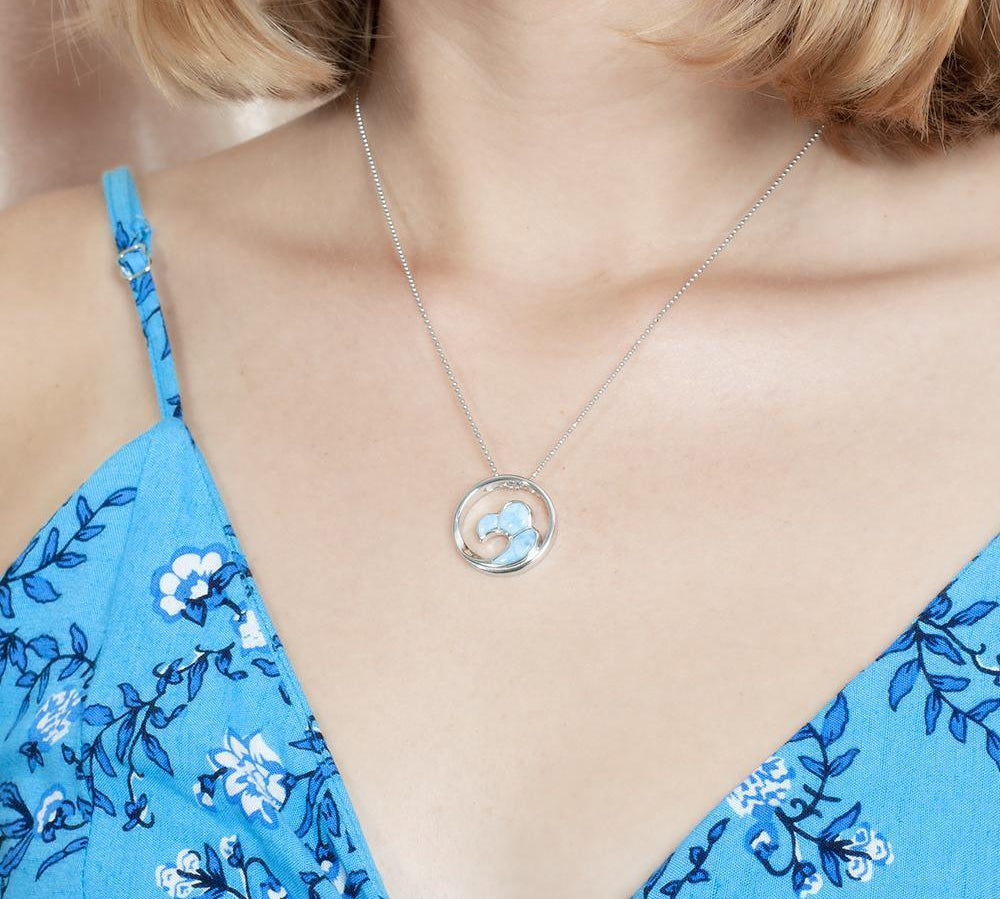 The picture shows a model wearing a 925 sterling silver larimar big wave pendant.