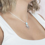 The picture shows a model wearing a 925 sterling silver larimar octopus pendant.