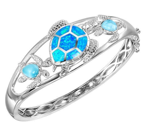 The picture shows a 925 sterling silver larimar and opalite 3 sea turtle bangle.