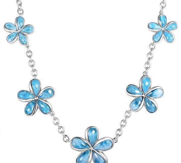 In this photo there is a sterling silver plumeria charm necklace with blue larimar gemstones.