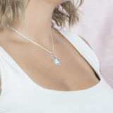 The picture shows a model wearing a 925 sterling silver larimar sea turtle pendant.