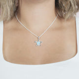 The picture shows a model wearing a 925 sterling silver larimar sea turtle pendant.