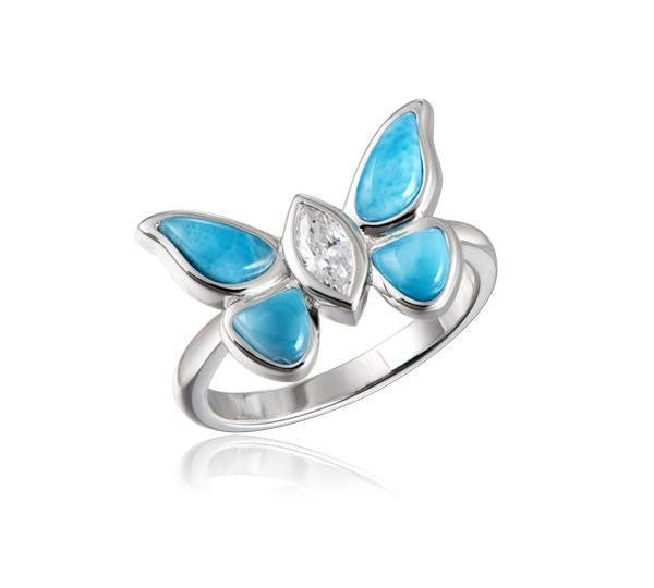 In this photo there is a 925 sterling silver butterfly ring with a blue larimar gemstone and aquamarine gemstones