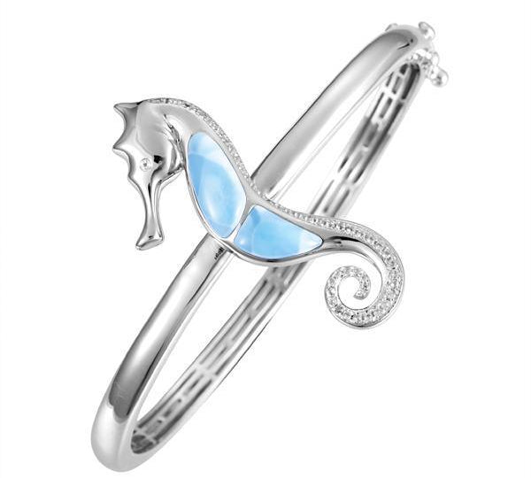 The picture shows a 925 sterling silver larimar seahorse bangle with topaz.