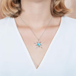 The picture shows a model wearing a 925 sterling silver larimar shooting star pendant.