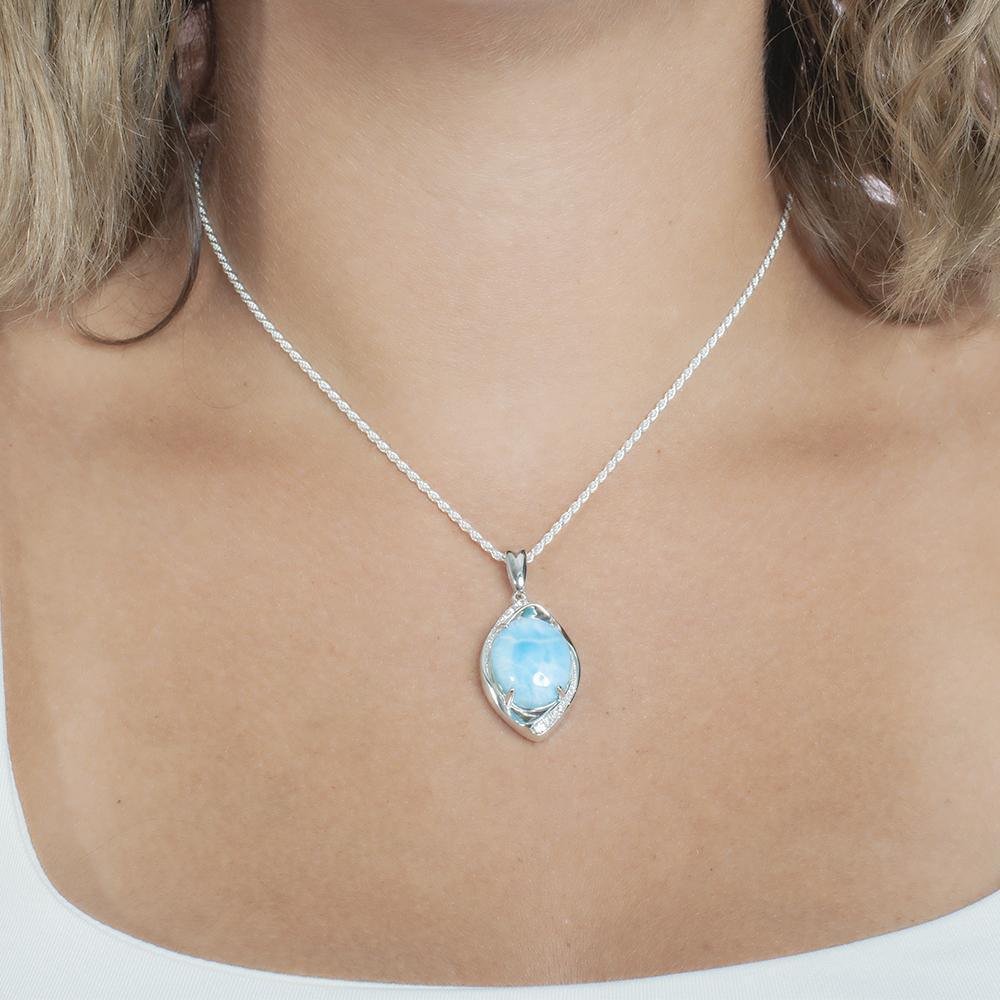 The picture shows a model wearing a 925 sterling silver larimar sparkling eye pendant.