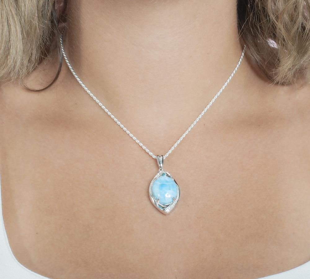 The picture shows a model wearing a 925 sterling silver larimar sparkling eye pendant.