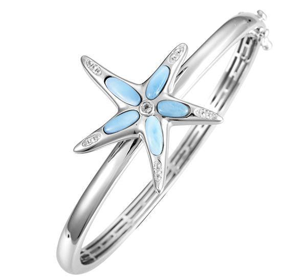 The picture shows a 925 sterling silver larimar sea star bangle with topaz.