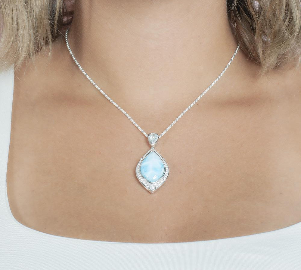 The picture shows a model wearing a 925 sterling silver larimar stars slign mandorla pendant.