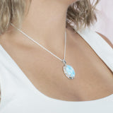 The picture shows a model wearing a 925 sterling silver larimar stars align pendant.