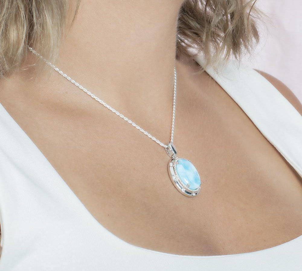 The picture shows a model wearing a 925 sterling silver larimar stars align pendant.