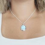 The picture shows a model wearing a 925 sterling silver larimar stars align pendant.