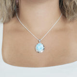 The picture shows a model wearing a 925 sterling silver larimar stars align pendant.