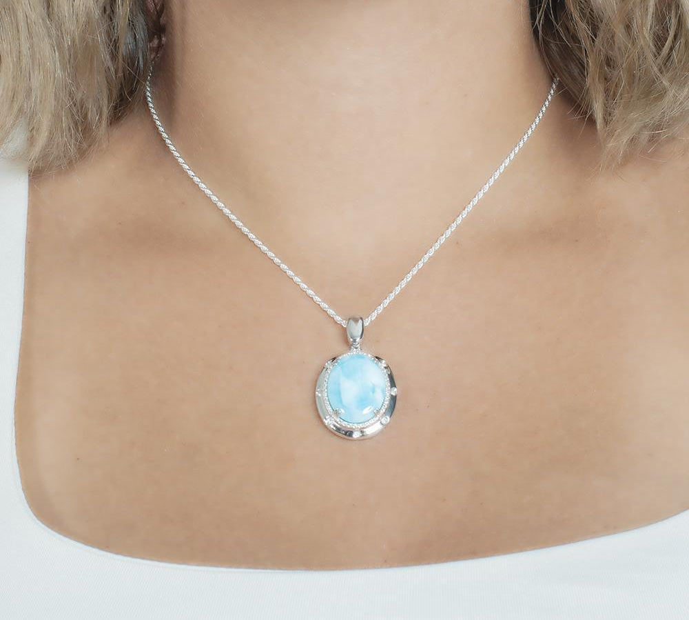 The picture shows a model wearing a 925 sterling silver larimar stars align pendant.