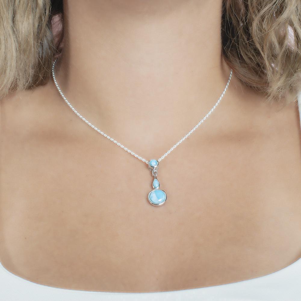 The picture shows a model wearing a 925 sterling silver larimar pendant featuring two circles and a teardrop in the center.