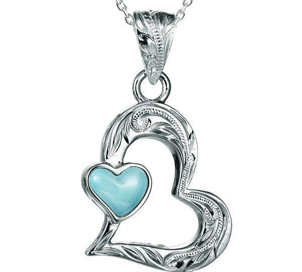 The photo shows a sterling silver larimar pendant featuring a heart shape. 