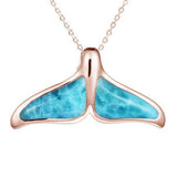 The picture shows a 14K rose gold larimar whale tail pendant.