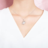 The picture shows a model wearing a 925 sterling silver crab pendant.