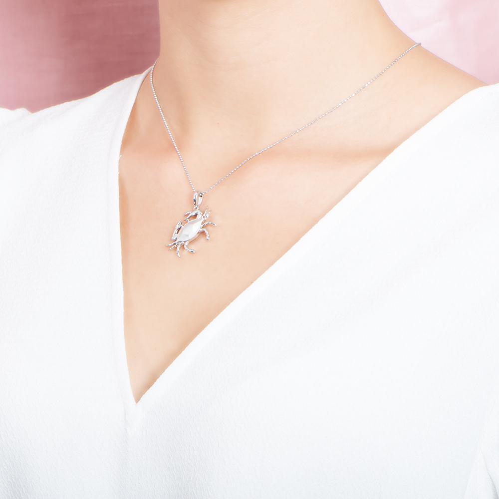 The picture shows a model wearing a 925 sterling silver crab pendant.