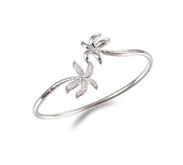 In this photo there is a 925 sterling silver bangle with two palm trees and topaz gemstones.