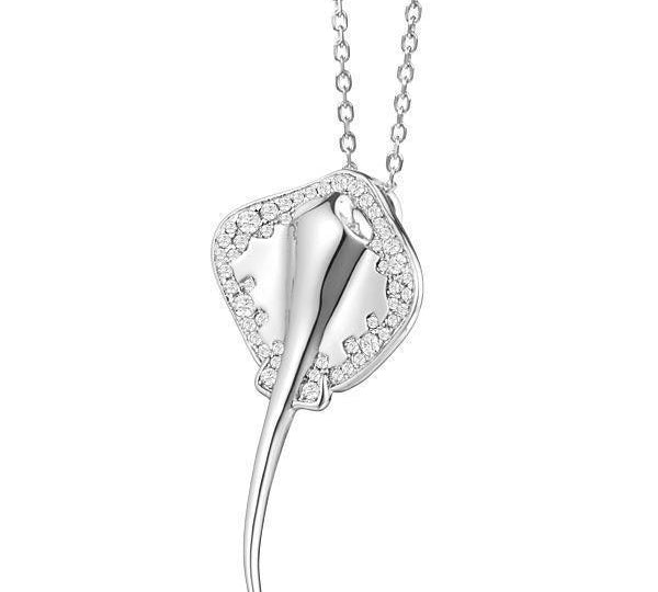 The picture shows a white gold manta ray pendant with topaz.