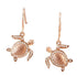 The picture shows a pair of 14K rose gold sea turtle hook earrings with diamonds.