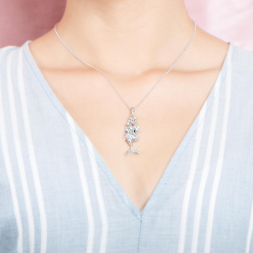 The picture shows a model wearing a 925 sterling silver mermaid pendant.