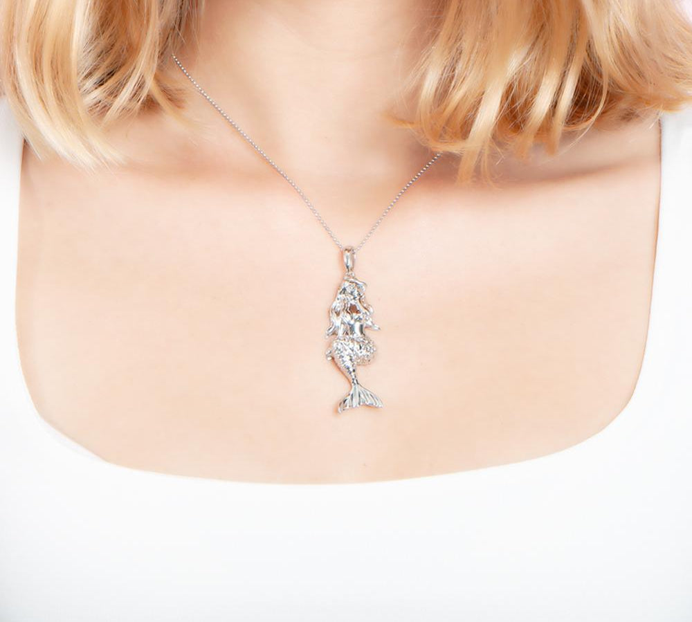 The picture shows a model wearing a 925 sterling silver mermaid pendant.