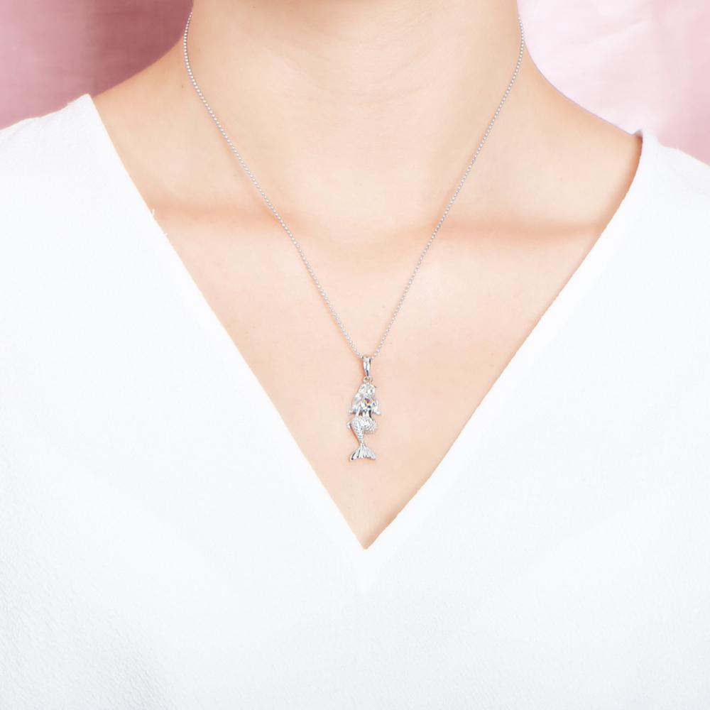 The picture shows a model wearing a 925 sterling silver mermaid pendant.
