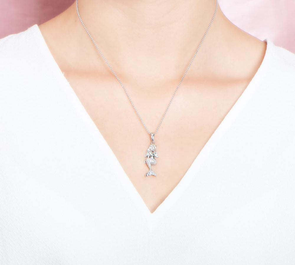 The picture shows a model wearing a 925 sterling silver mermaid pendant.