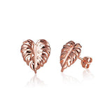 In this photo there is a pair of 14k rose gold monstera stud earrings.