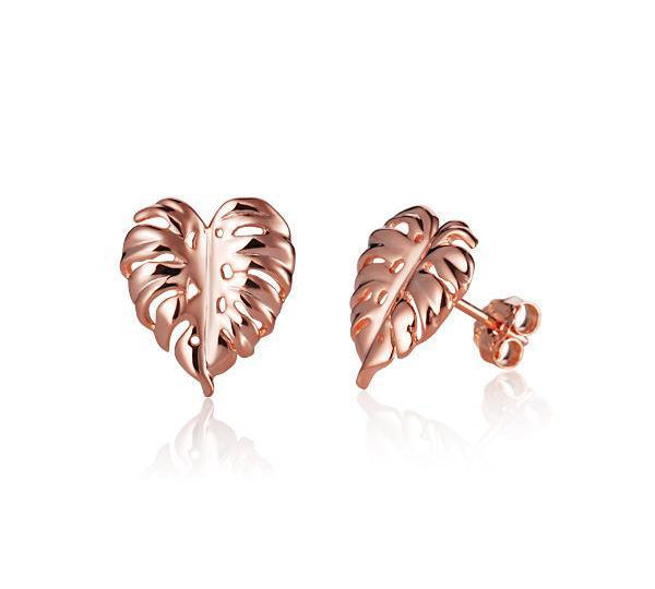 In this photo there is a pair of 14k rose gold monstera stud earrings.