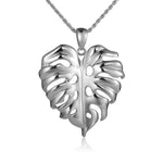 In this photo there is a white gold monstera pendant.