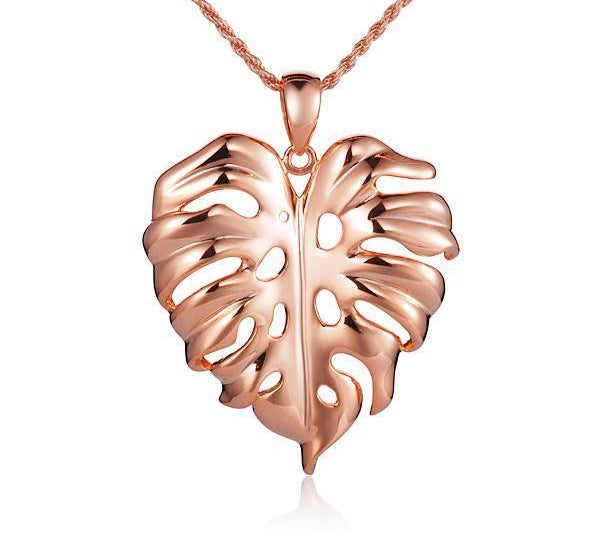 In this photo there is a rose gold monstera pendant.