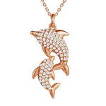 The picture shows a 14K rose gold dolphin lovers pendant with diamonds pendant.