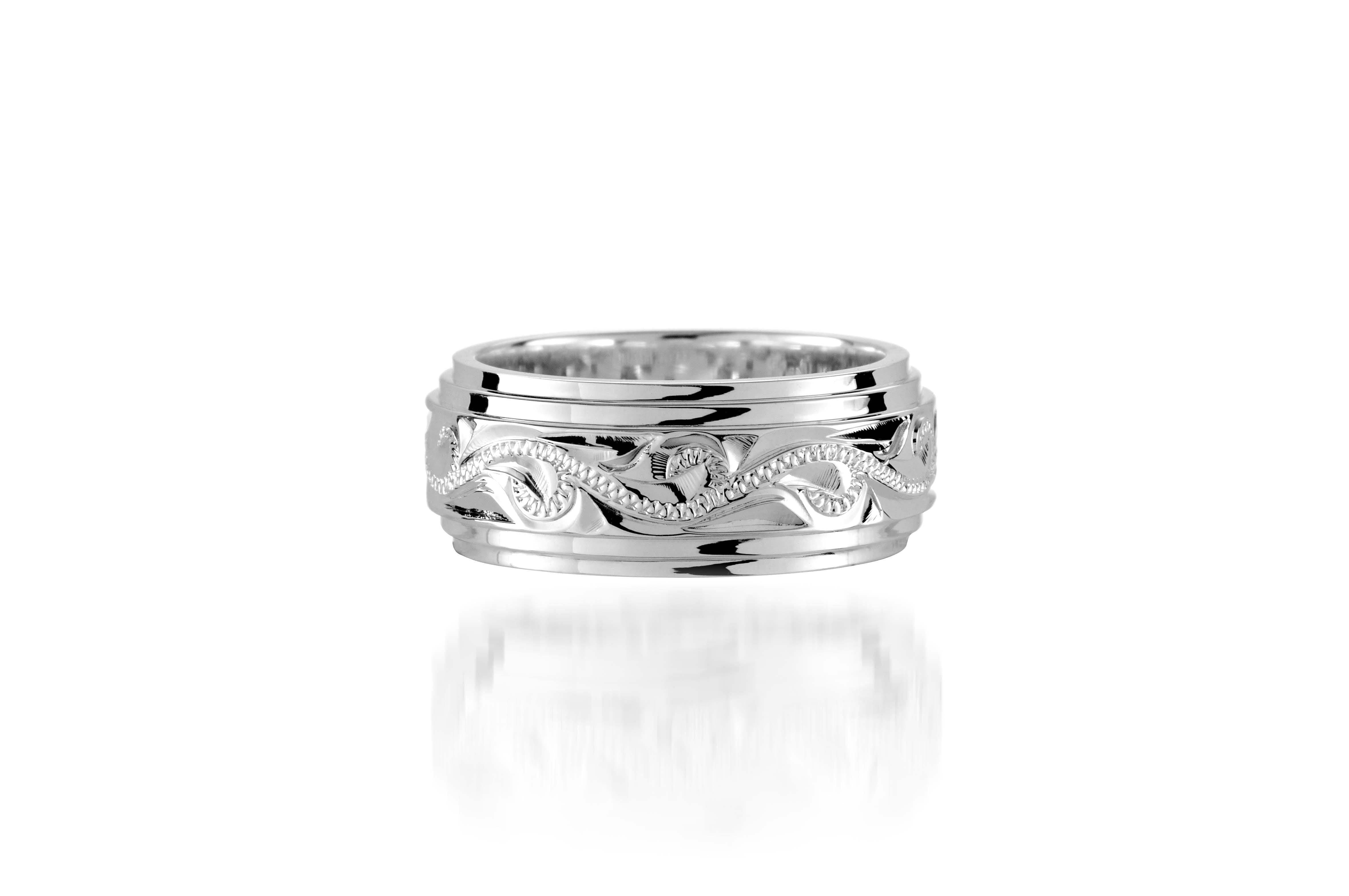 The picture shows a 925 sterling silver 8 mm ring with hand engravings of scrolls.