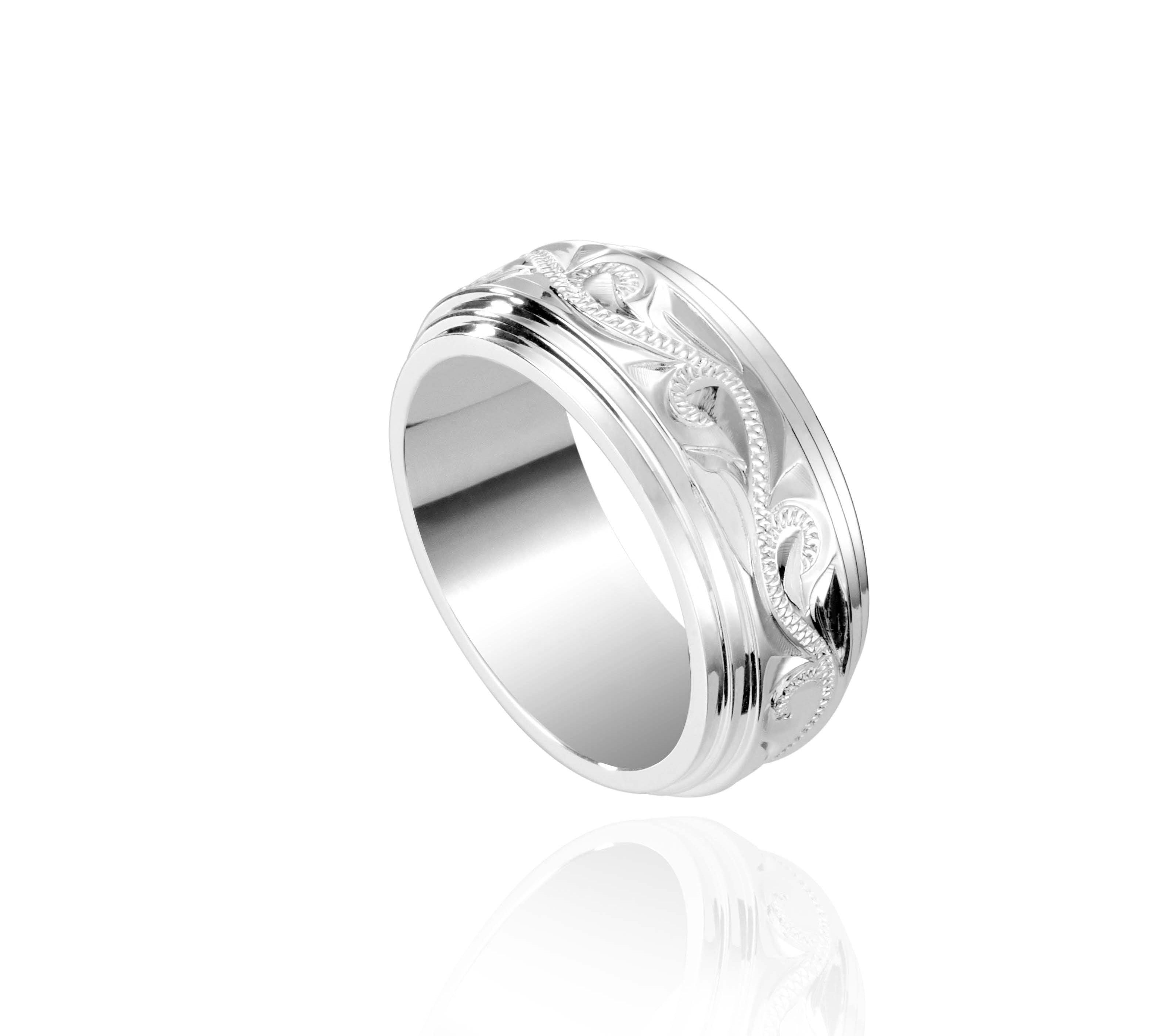 The picture shows a 925 sterling silver 8 mm ring with hand engravings of scrolls.
