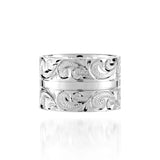 The picture shows a 925 sterling silver 12 mm ring with hand engravings of scrolls.