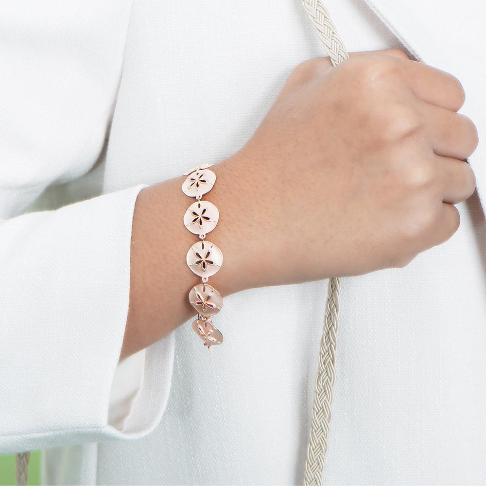 The picture shows a 925 sterling silver rose gold-plated sand dollar bracelet with topaz