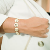 The picture shows a 925 sterling silver yellow gold-plated sand dollar bracelet with topaz