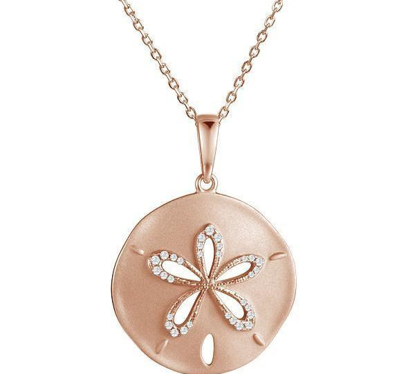 The picture shows a 14K rose gold sand dollar cut out pendant with diamonds.
