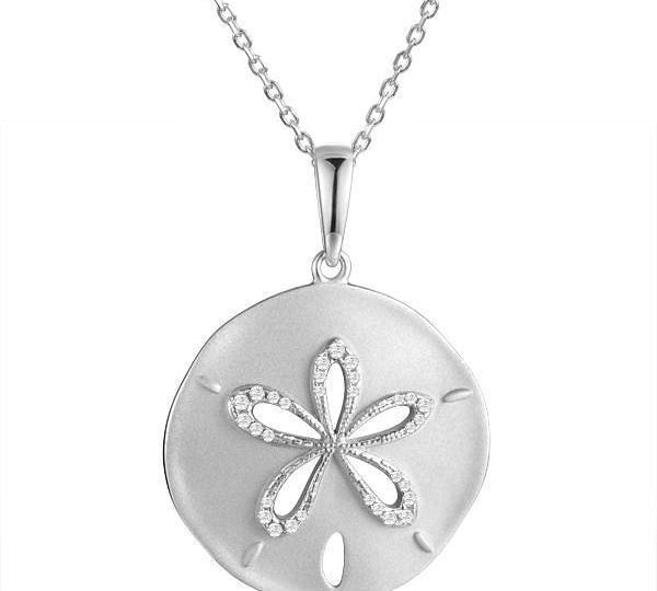The picture shows a 14K white gold sand dollar cut out pendant with diamonds.