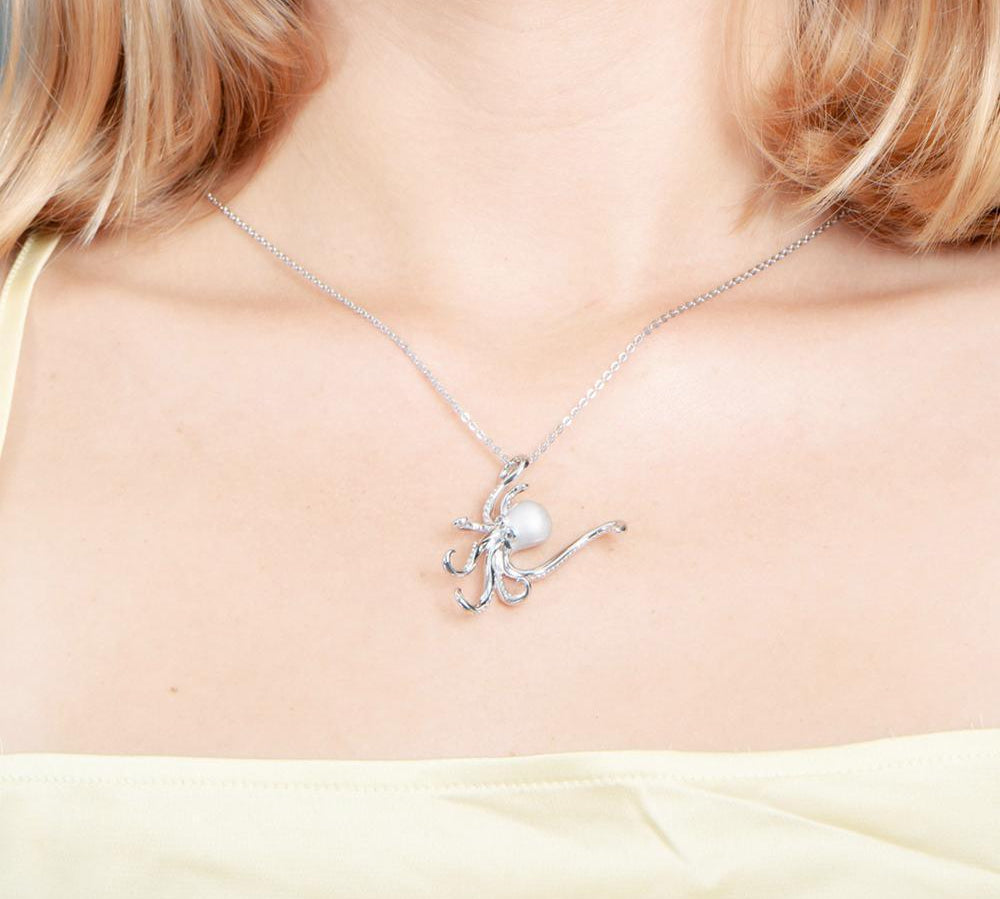 The picture shows a model wearing a 925 sterling silver octopus pendant with topaz.
