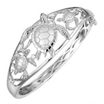 The picture shows a 925 sterling silver three sea turtle bangle with topaz.