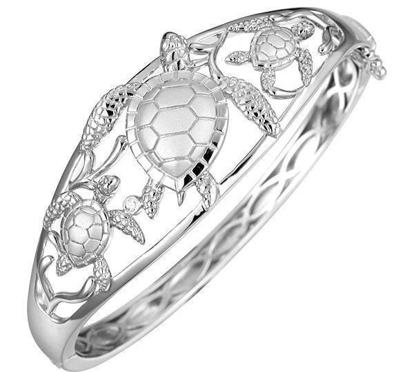 The picture shows a 925 sterling silver three sea turtle bangle with topaz.